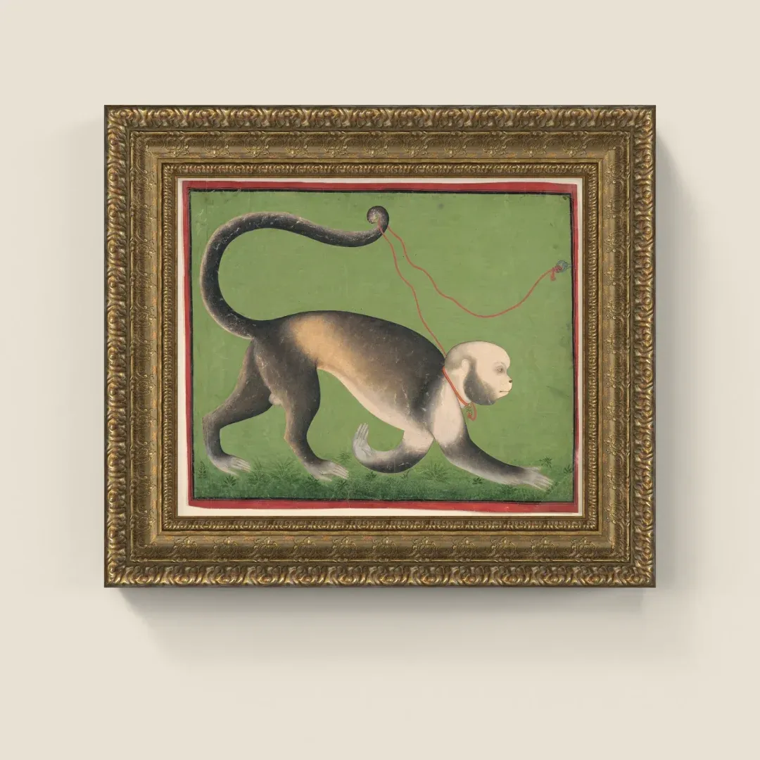 A painting of a monkey in a carved gold ornate frame